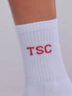 White sock with red 'TSC' text on a neutral background
